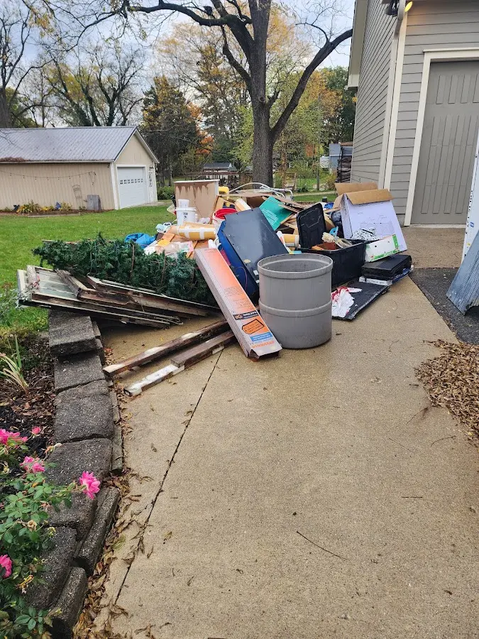 Dumpster being loaded with debris for 12 Yard Dumpster Rental in Marcellus
